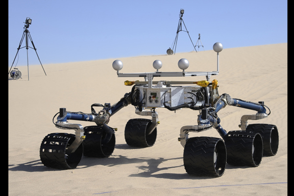 Members of the Mars Science Laboratory/ Curiosity team including rover drivers and scientists tests out  an engineering model of its next generation Mars rover dubbed "Curiosity" in the Dumont Dunes near Baker, California May 10, 2012.